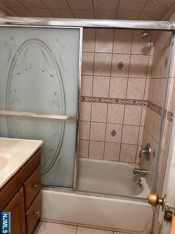 a bathroom with a bathtub and shower