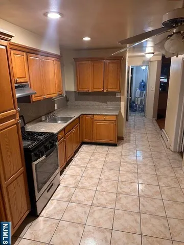 a kitchen with stainless steel appliances granite countertop a refrigerator and a stove