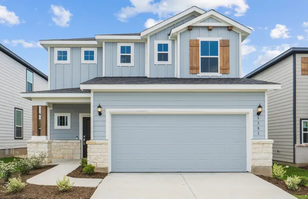 a front view of a house with garage