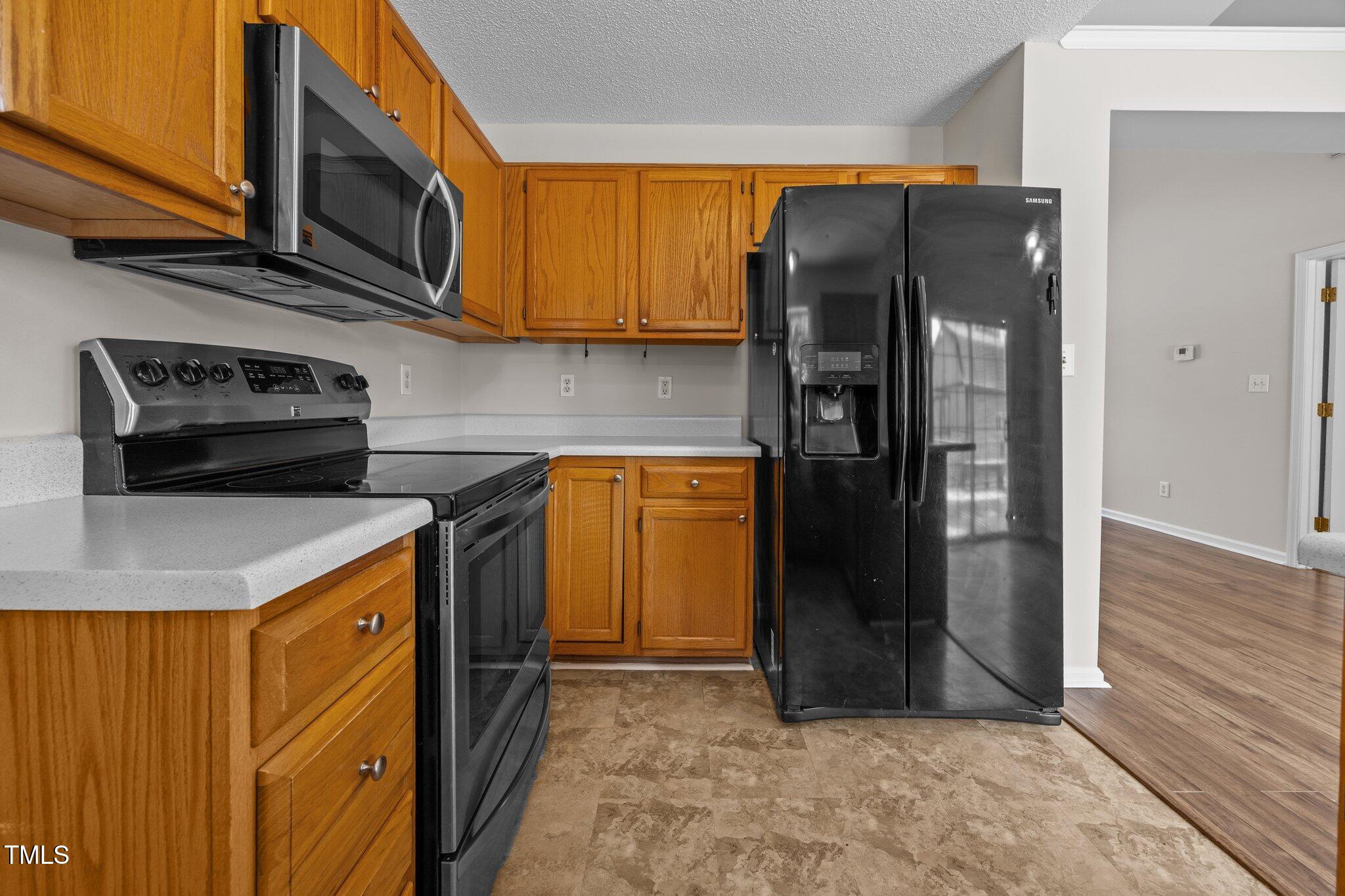 408 Flagg Road Holly Springs, NC 27540 - Photo 14 of 32 a kitchen with stainless steel appliances granite countertop a refrigerator and a stove