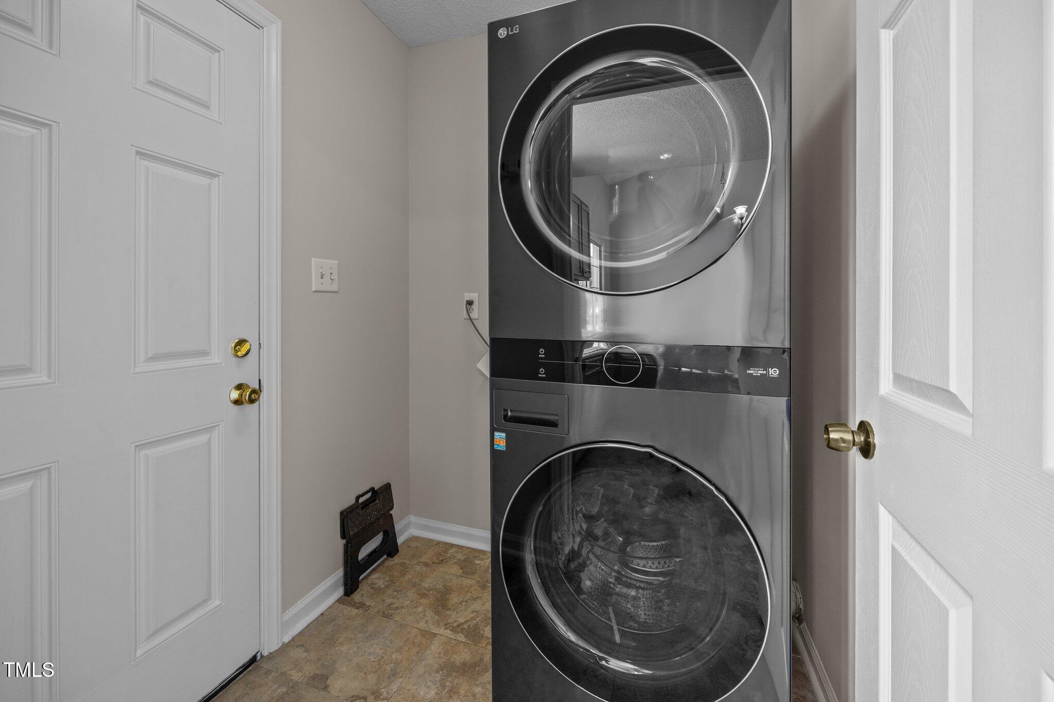 408 Flagg Road Holly Springs, NC 27540 - Photo 15 of 32 a close view of a utility room with washer and dryer