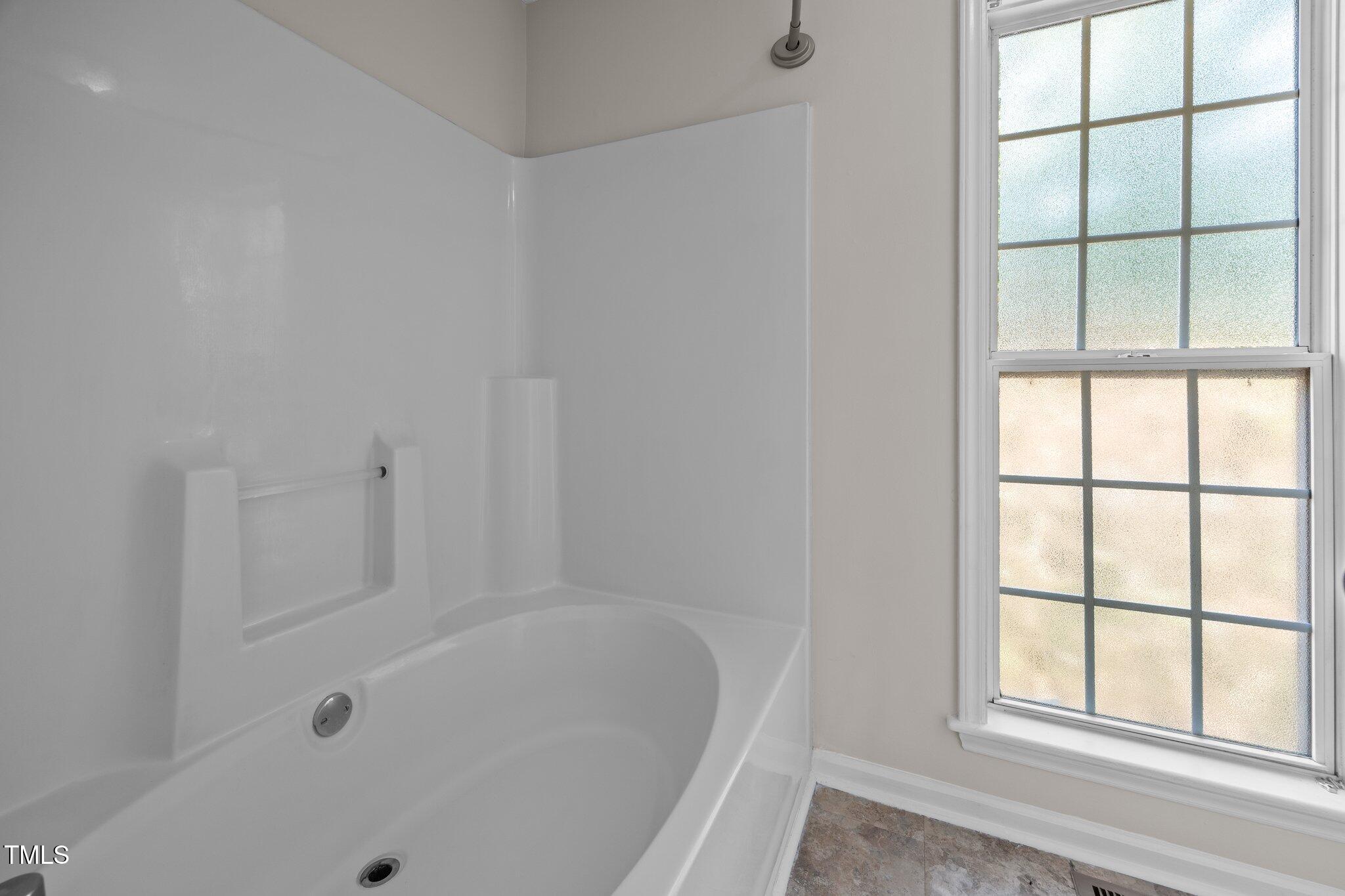 408 Flagg Road Holly Springs, NC 27540 - Photo 19 of 32 a white bath tub sitting next to a window