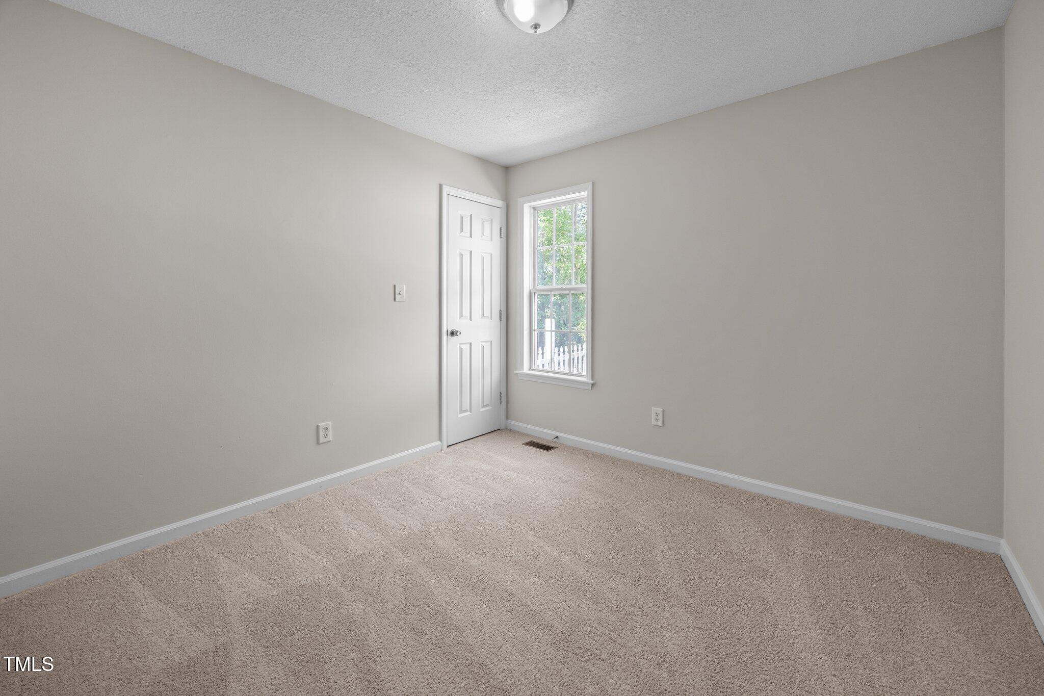 408 Flagg Road Holly Springs, NC 27540 - Photo 21 of 32 an empty room with windows and closet