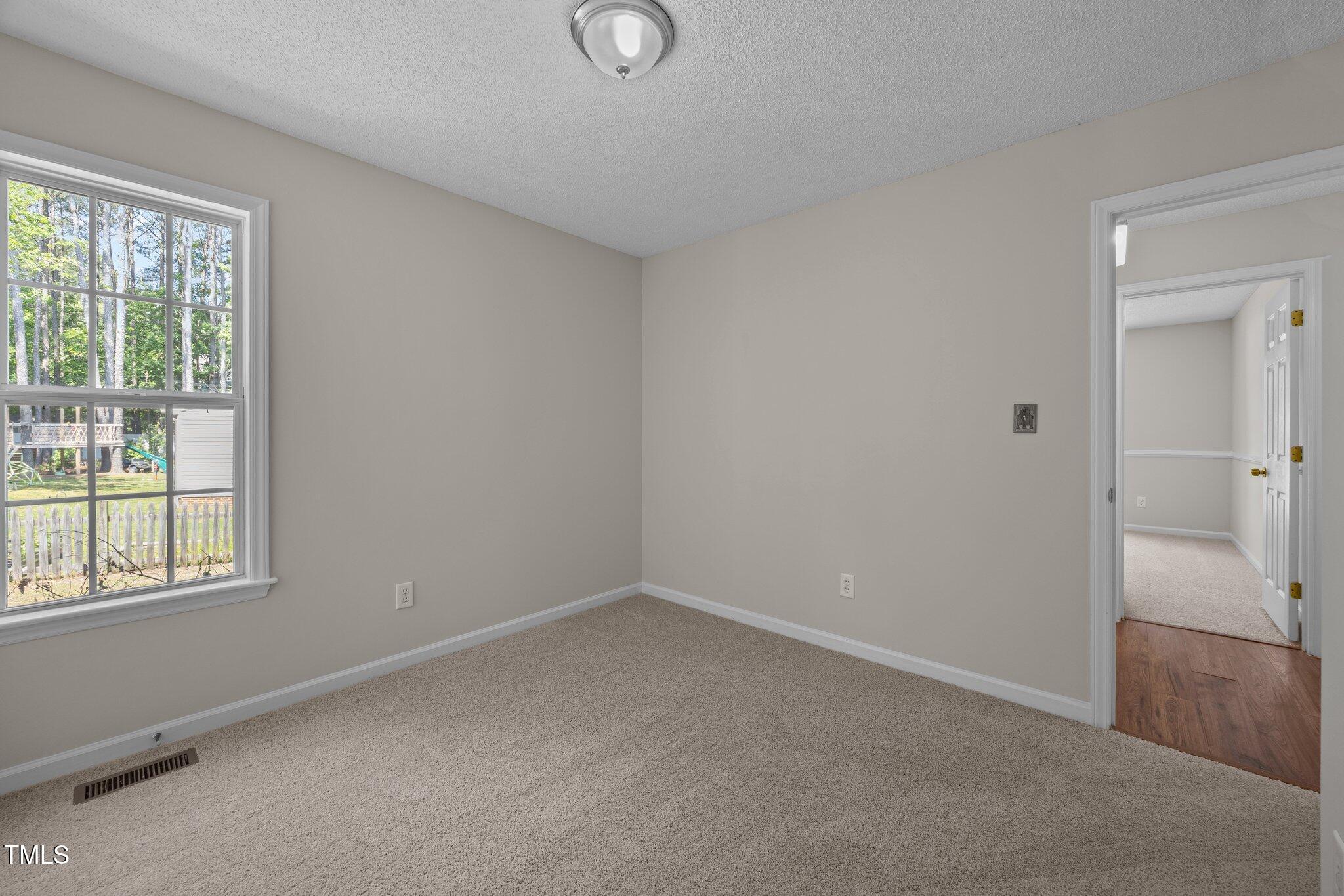 408 Flagg Road Holly Springs, NC 27540 - Photo 22 of 32 a view of an empty room with a window