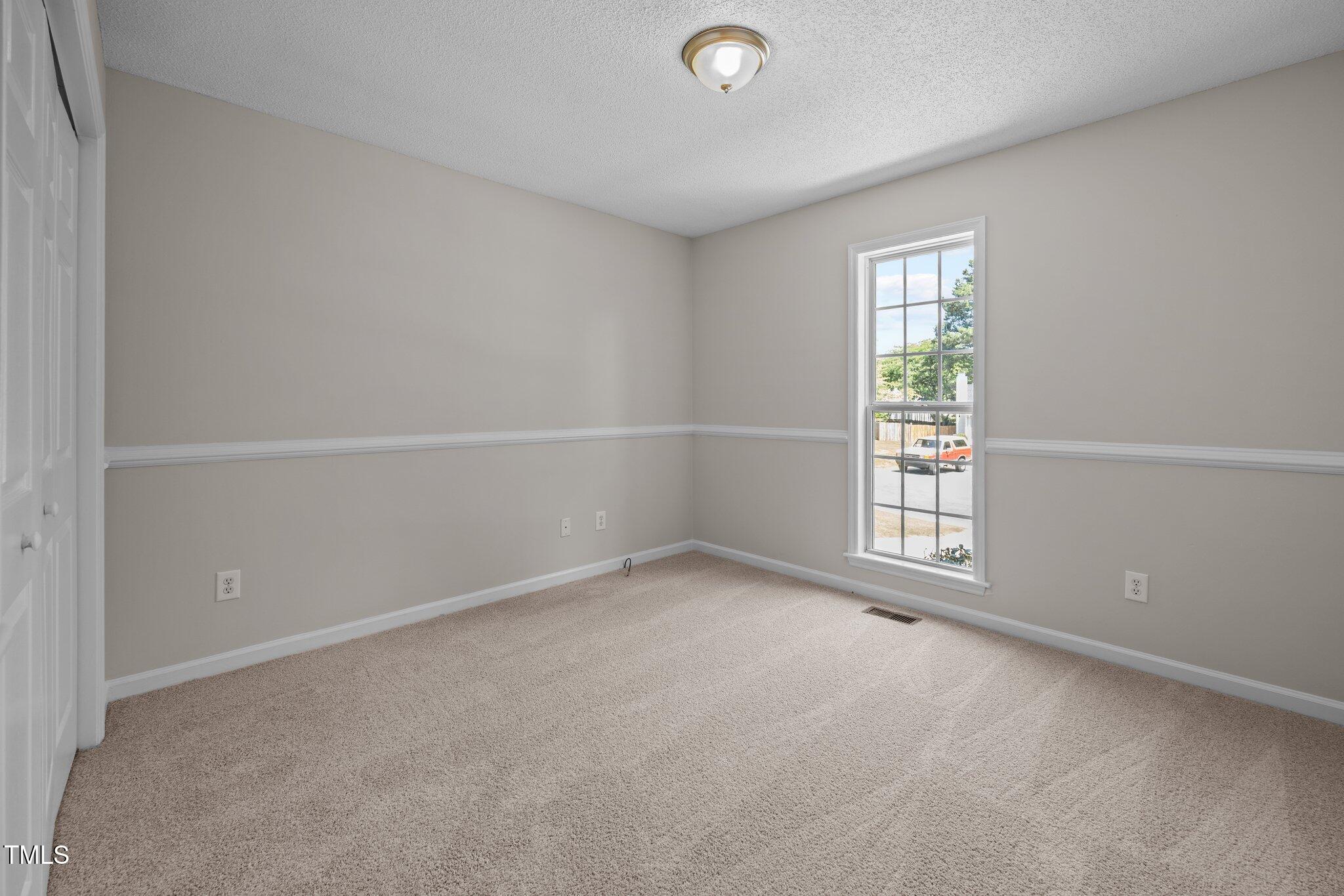 408 Flagg Road Holly Springs, NC 27540 - Photo 23 of 32 an empty room with a empty space and windows