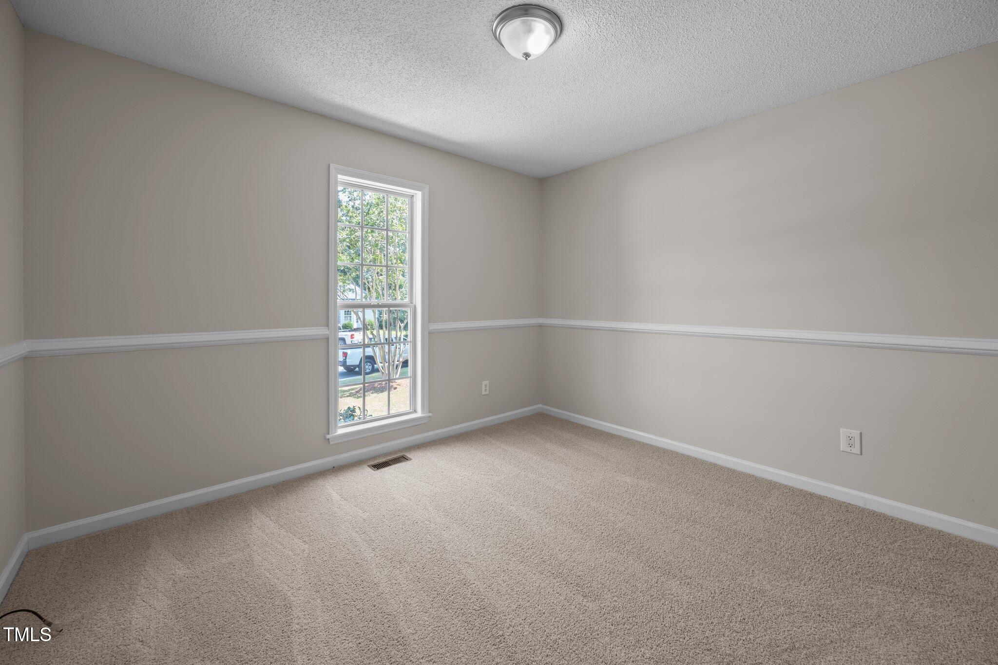 408 Flagg Road Holly Springs, NC 27540 - Photo 24 of 32 an empty room with windows