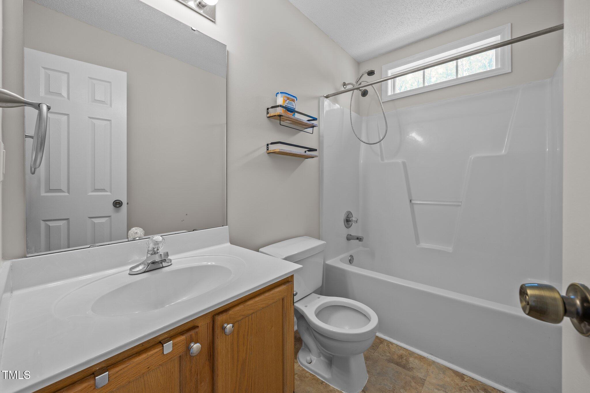 408 Flagg Road Holly Springs, NC 27540 - Photo 25 of 32 a bathroom with a sink a toilet and shower
