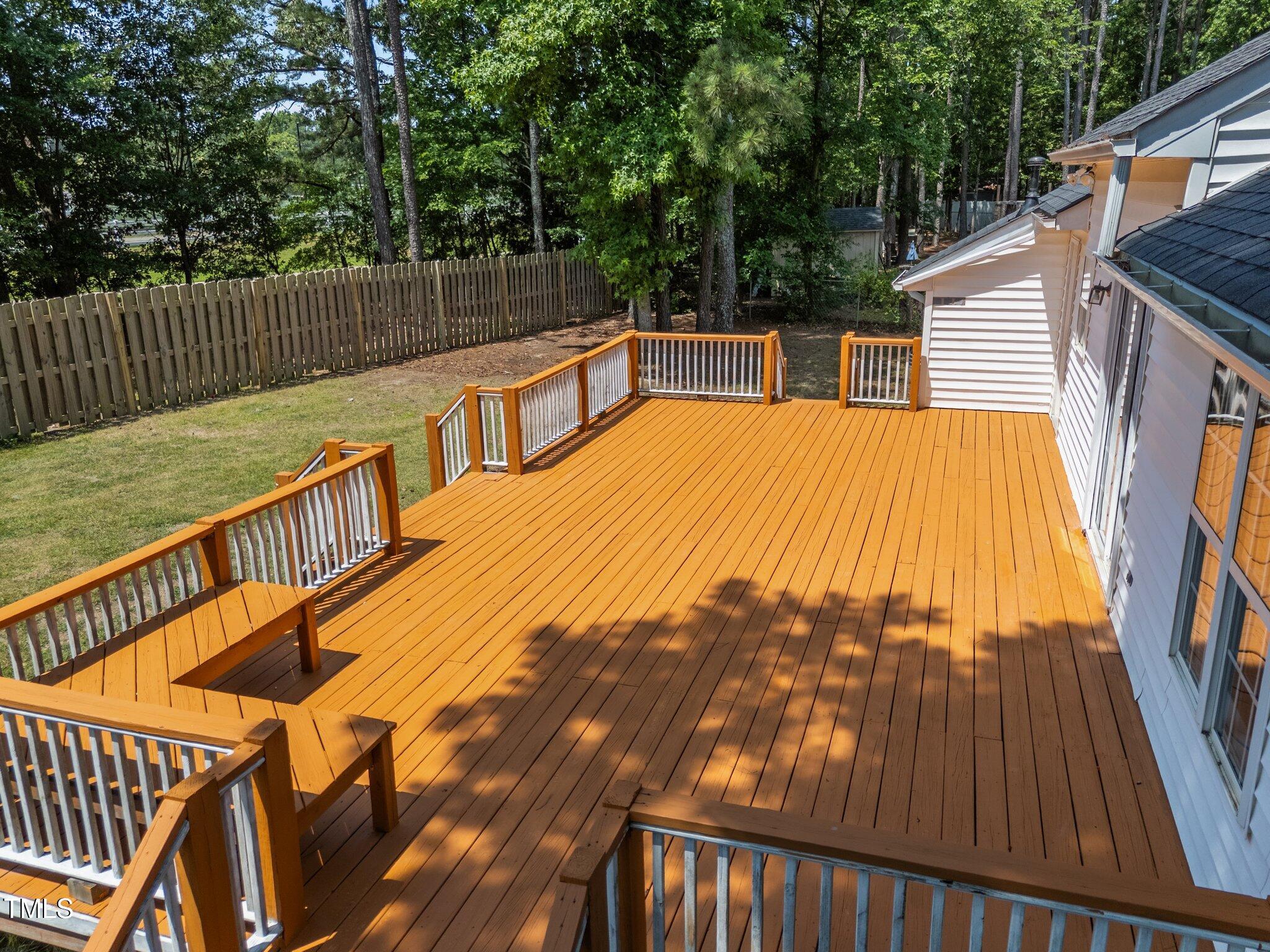 408 Flagg Road Holly Springs, NC 27540 - Photo 26 of 32 a view of swimming pool with a couches chairs and wooden fence