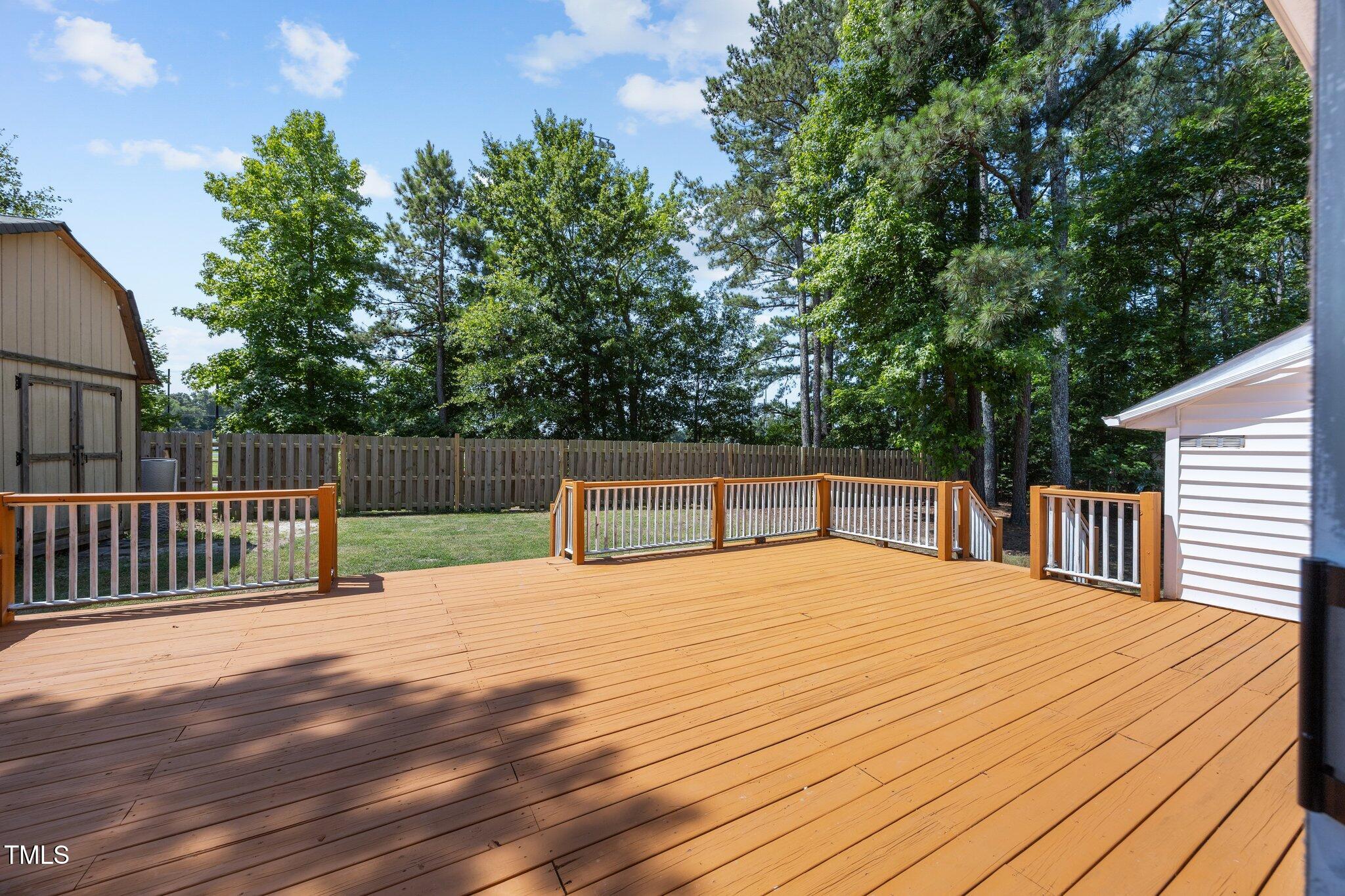 408 Flagg Road Holly Springs, NC 27540 - Photo 27 of 32 a view of backyard with deck and wooden floor