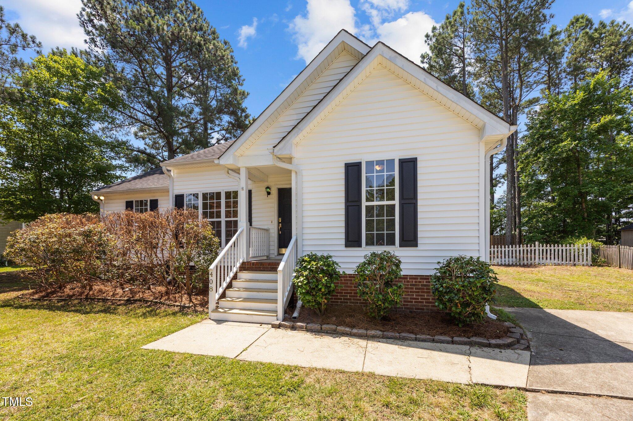 408 Flagg Road Holly Springs, NC 27540 - Photo 3 of 32 a front view of a house with a yard
