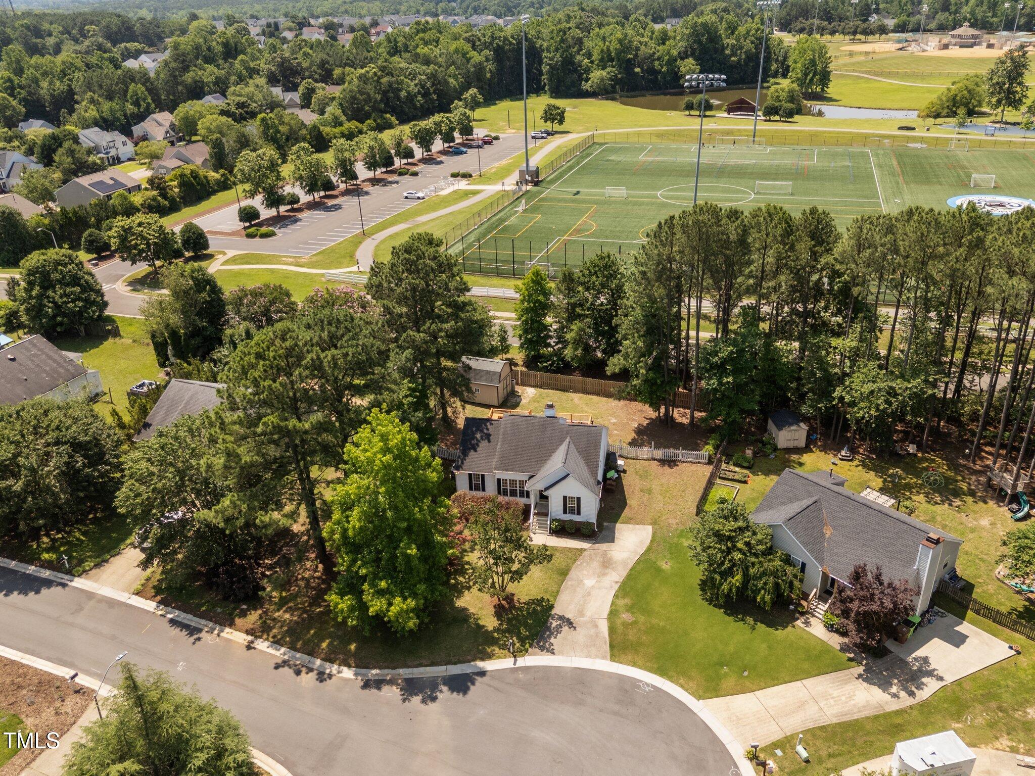 408 Flagg Road Holly Springs, NC 27540 - Photo 31 of 32 an aerial view of a house with a swimming pool yard and lake view