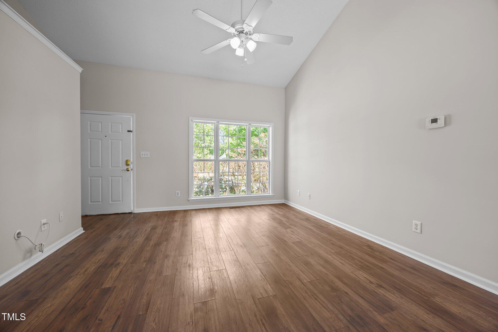 408 Flagg Road Holly Springs, NC 27540 - Photo 6 of 32 wooden floor in an empty room with a window