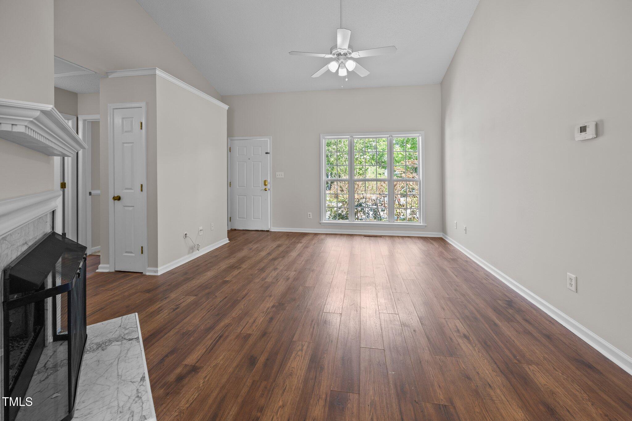 408 Flagg Road Holly Springs, NC 27540 - Photo 9 of 32 wooden floor in an empty room with a window