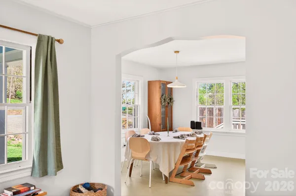 a dining room with furniture and window