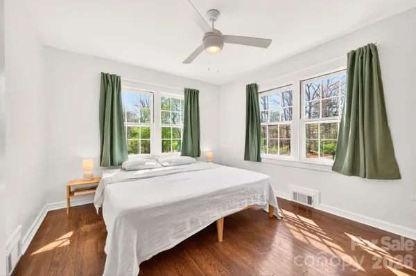 a bedroom with a bed and a large window