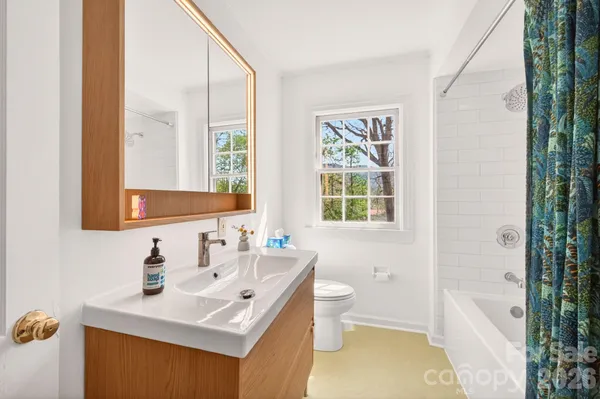 a bathroom with a sink toilet tub and shower