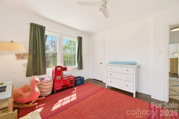 a bedroom with furniture and a window