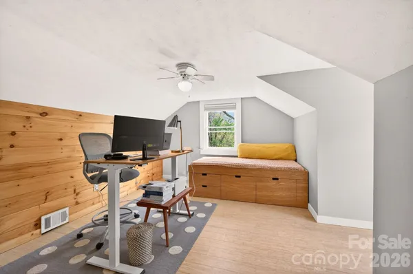 a bedroom with a workspace