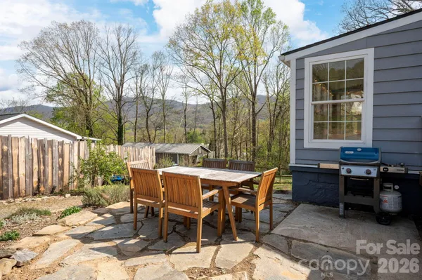 a view of a dinning table and chairs in the patio