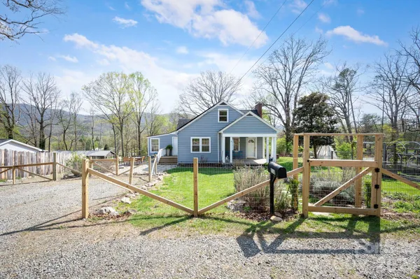 a view of a house with backyard wooden fence
