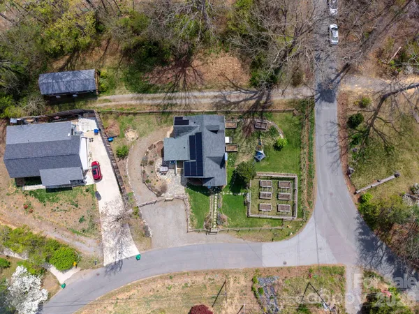 an aerial view of a house with a yard and potted plants
