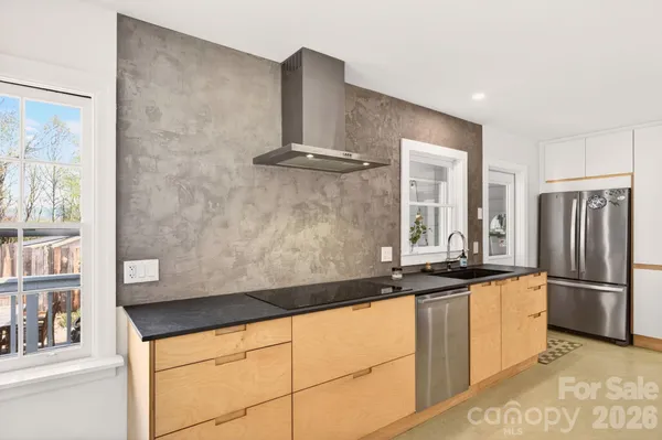 a kitchen with granite countertop a sink and stainless steel appliances