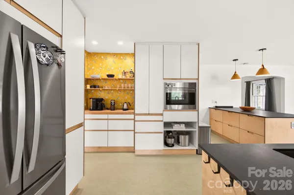 a kitchen with stainless steel appliances granite countertop a refrigerator and a stove