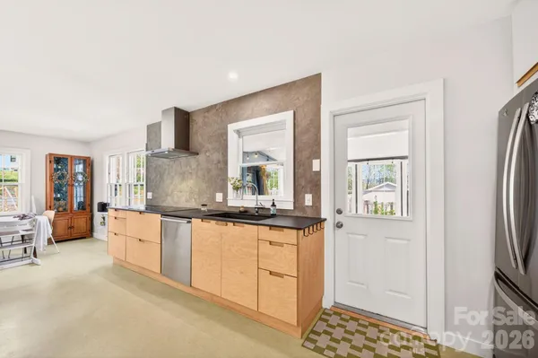 a kitchen with stainless steel appliances a sink stove and refrigerator