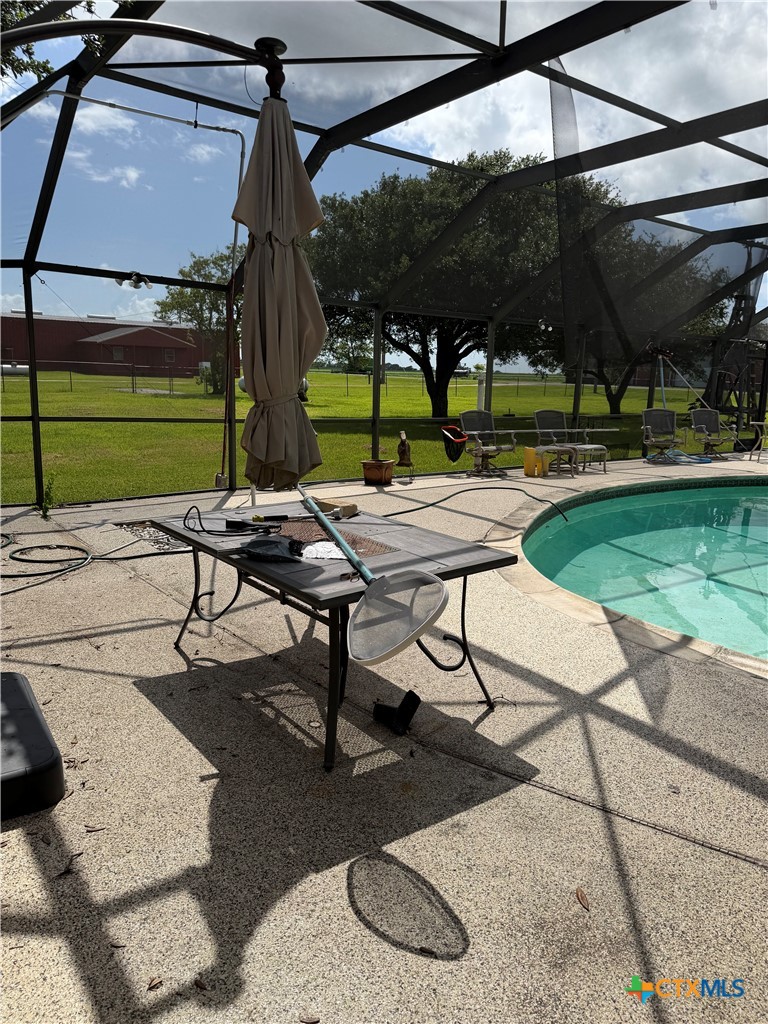 57 John Tillery Road Port Lavaca, TX 77979 - Photo 34 of 34 a view of a patio with a table and chairs under an umbrella