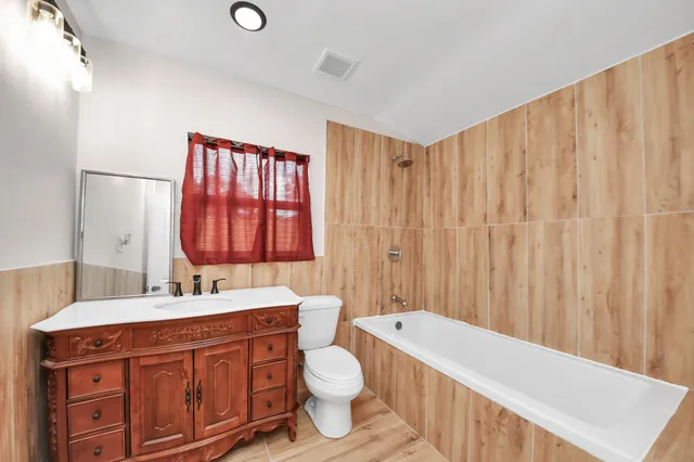 a bathroom with a toilet a sink and a bathtub