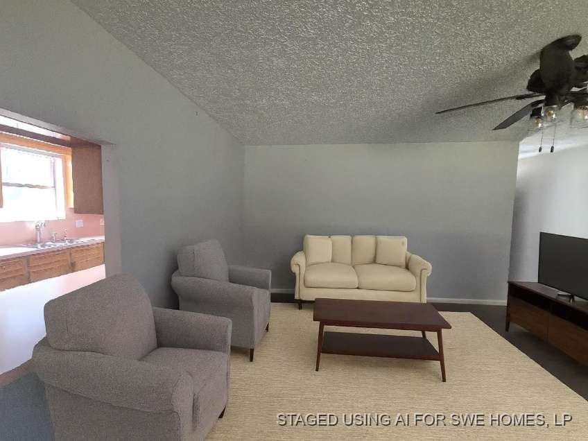 509 Bobcat Lane Daisetta, TX 77533 - Photo 3 of 13 a living room with furniture a flat screen tv and a window
