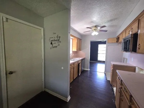a kitchen with stainless steel appliances granite countertop a sink and a microwave
