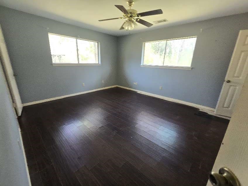 509 Bobcat Lane Daisetta, TX 77533 - Photo 8 of 13 a view of an empty room with wooden floor and a window