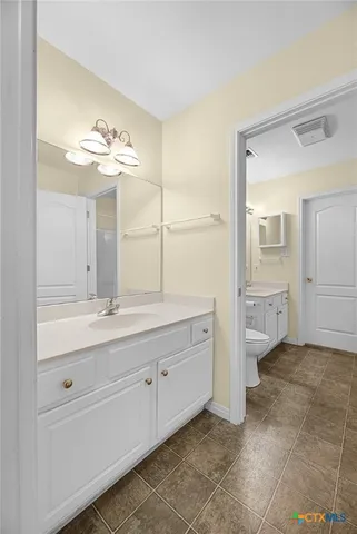 a front view of a house with a garden and yard