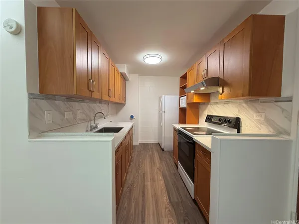 a kitchen with granite countertop stainless steel appliances and wooden cabinets