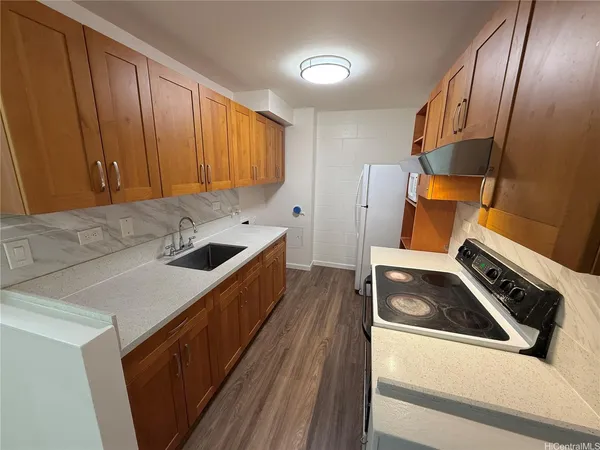 a kitchen that has a sink and a stove