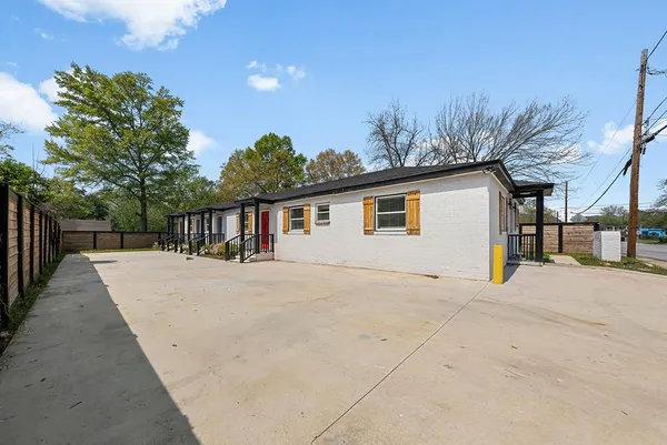 a view of house with outdoor space and sitting area