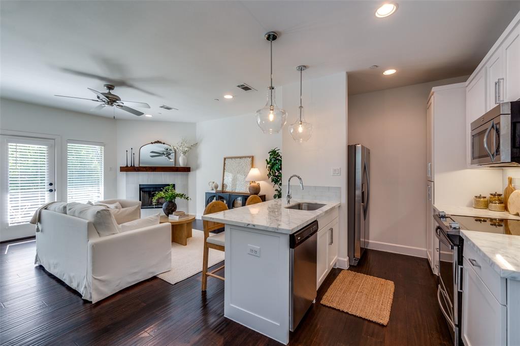 5830 Oram Street, Unit 5 Dallas, TX 75206 - Photo 12 of 18 a kitchen with kitchen island a sink stove and refrigerator
