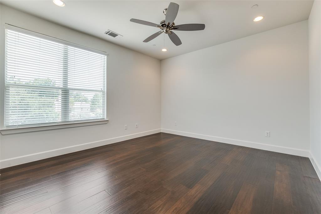 5830 Oram Street, Unit 5 Dallas, TX 75206 - Photo 5 of 18 an empty room with wooden floor and windows