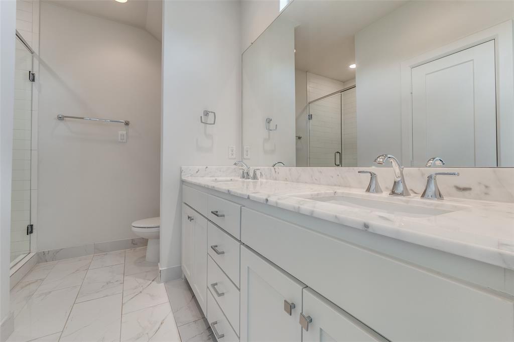 5830 Oram Street, Unit 5 Dallas, TX 75206 - Photo 6 of 18 a bathroom with a granite countertop sink a toilet and a large mirror