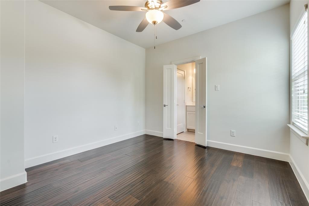 5830 Oram Street, Unit 5 Dallas, TX 75206 - Photo 7 of 18 an empty room with wooden floor and windows