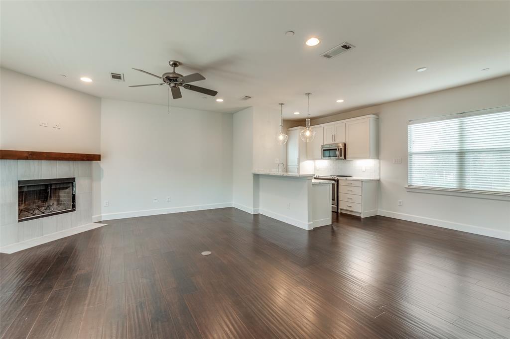 5830 Oram Street, Unit 5 Dallas, TX 75206 - Photo 18 of 18 an empty room with wooden floor a fireplace and windows