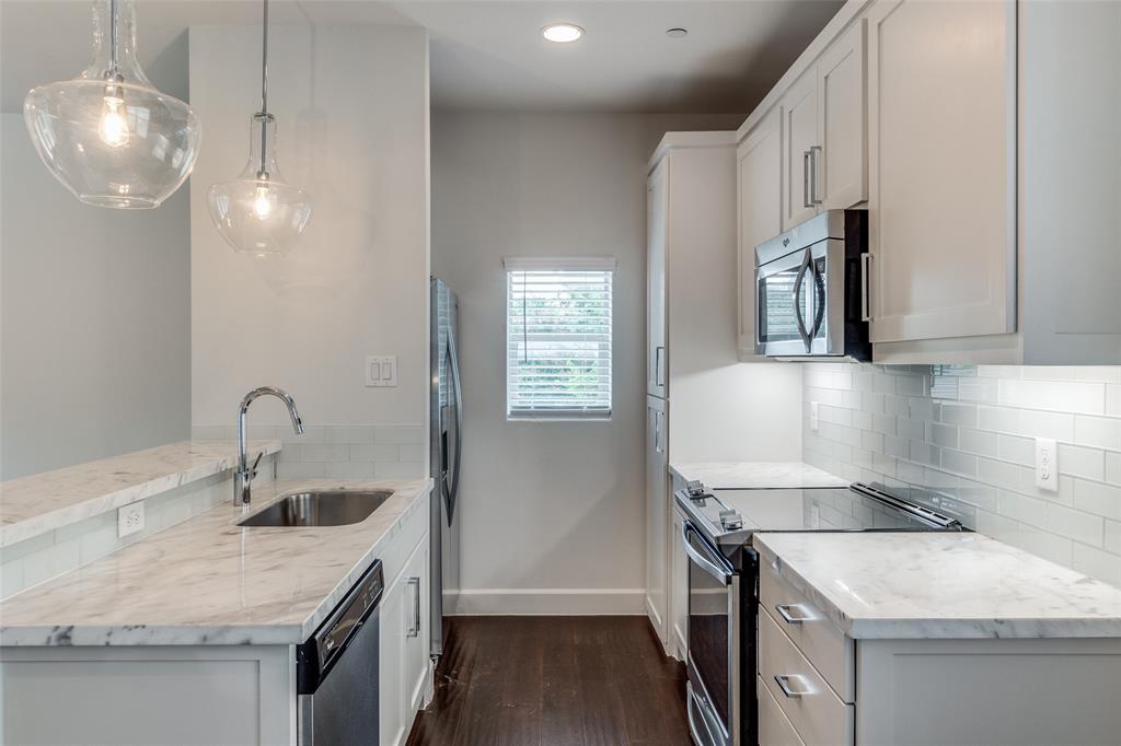 5830 Oram Street, Unit 5 Dallas, TX 75206 - Photo 2 of 18 a kitchen that has a sink stainless steel appliances and cabinets
