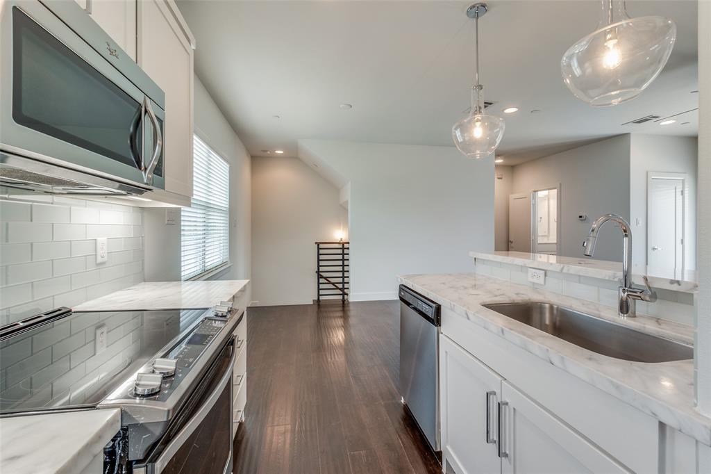 5830 Oram Street, Unit 5 Dallas, TX 75206 - Photo 3 of 18 a kitchen with stainless steel appliances granite countertop a sink and a microwave