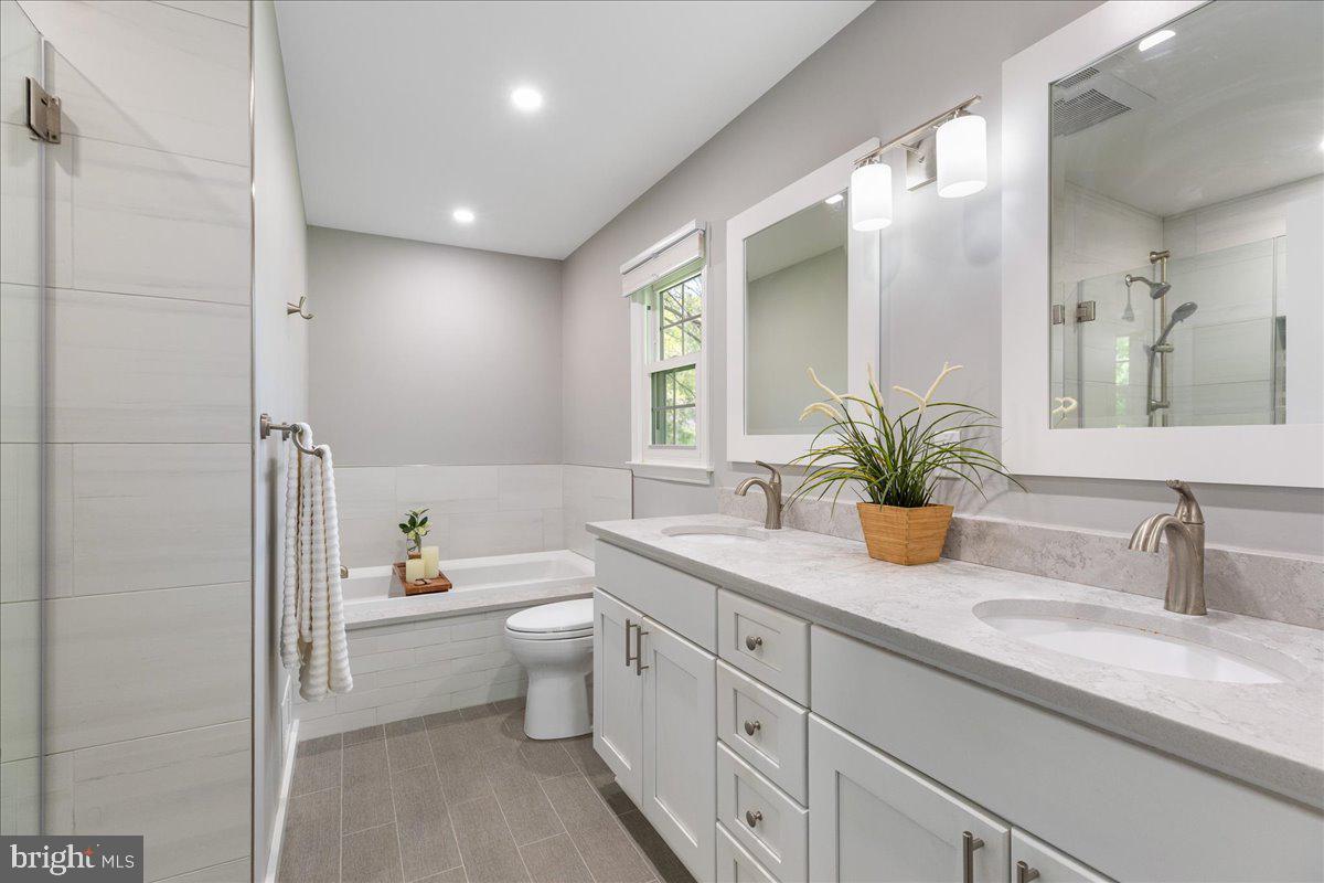 3 Strathmore Place Princeton Junction, NJ 08550 - Photo 18 of 29 a bathroom with a granite countertop sink a toilet a large mirror and shower