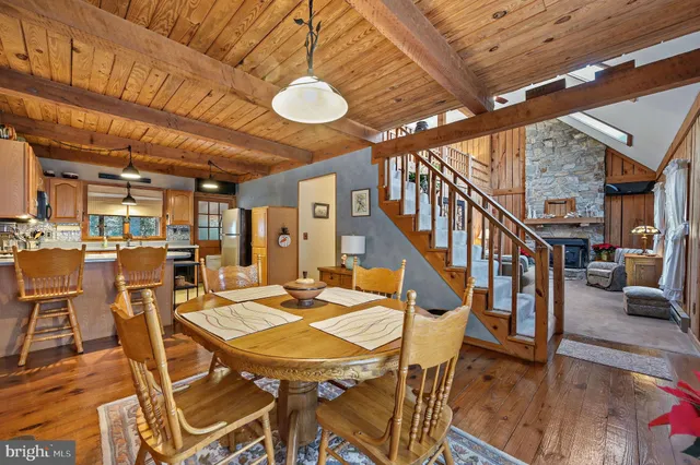 a view of a dining room with furniture a chandelier and wooden floor