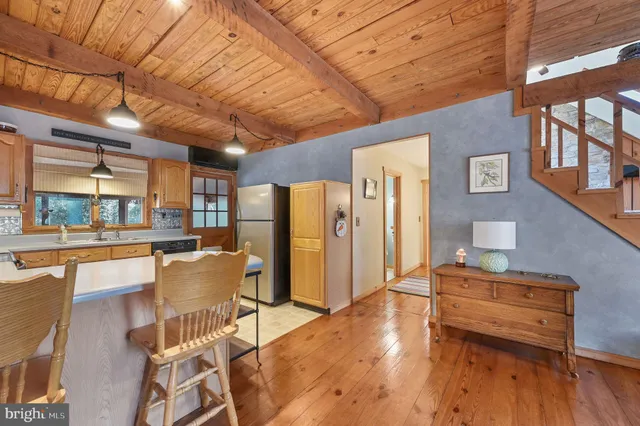 a dining room with furniture and wooden floor