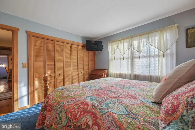 a bedroom with a large bed and a large window