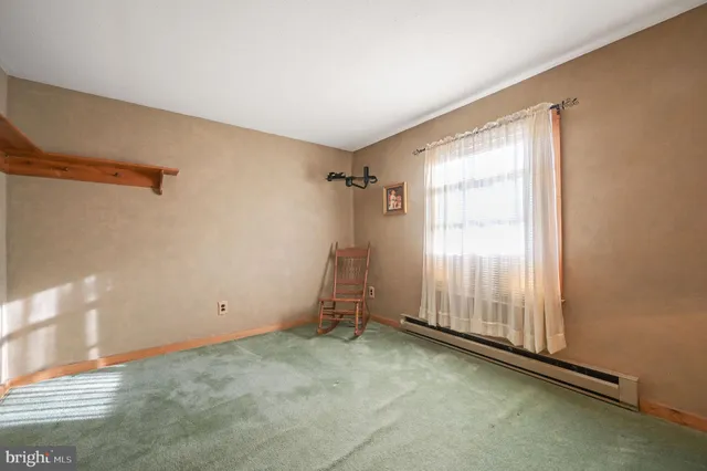 a view of a room with rack on the wall and a window