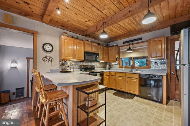 a kitchen with stainless steel appliances granite countertop a sink and cabinets